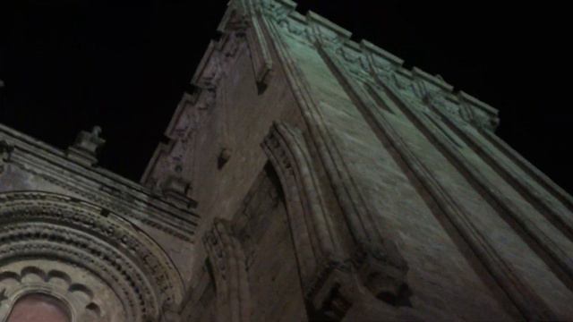 PLAYING MUSIC IN FRONT OF THE SANTIAGO COMPOSTELLA CATHOLIC CHURCH, AFTER CAMINO, IN THE NIGHT