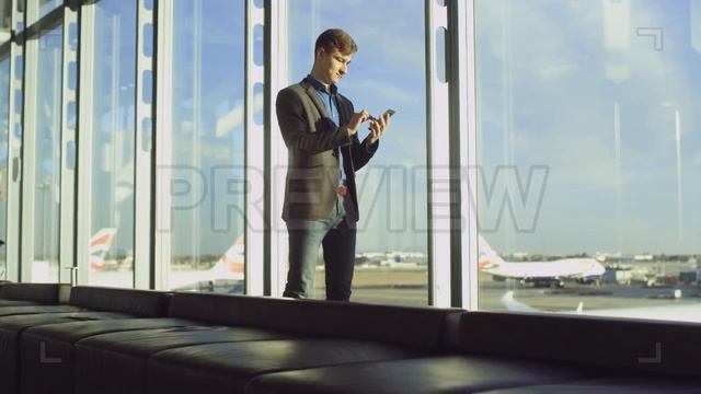 Man Texting In The Airport Stock Video