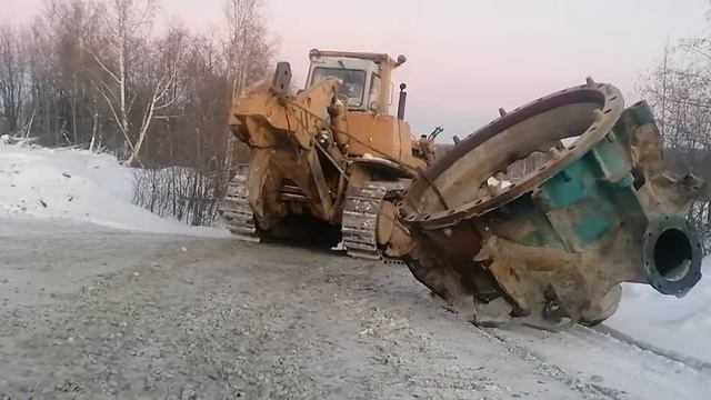 большой бульдозер тянет конусную дробилку . дорога, бульдозер, дробилка .