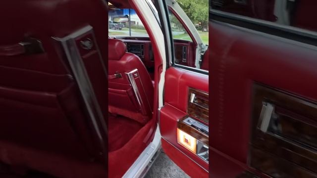Kamins Motorcars 1990 White/maroon Cadillac 4