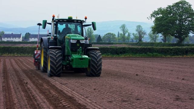 Planting Maize In The Field With John Deere 6R 215 And Planter Kverneland Optima V