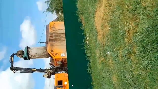Мусоровоз КАМАЗ грузит баки
