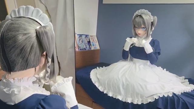 Кигуруми-кукла в длинном платье горничной сидит перед зеркалом.