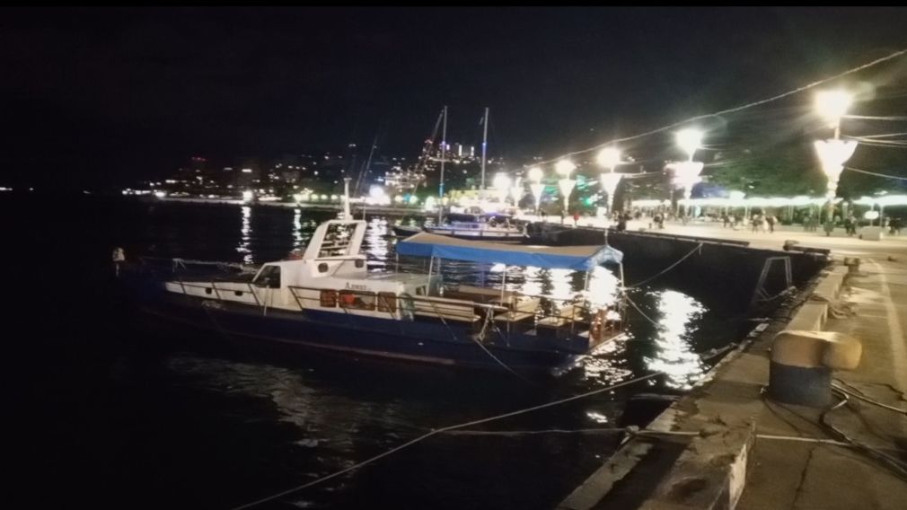 Ночной вид на причал с прогулочным катером