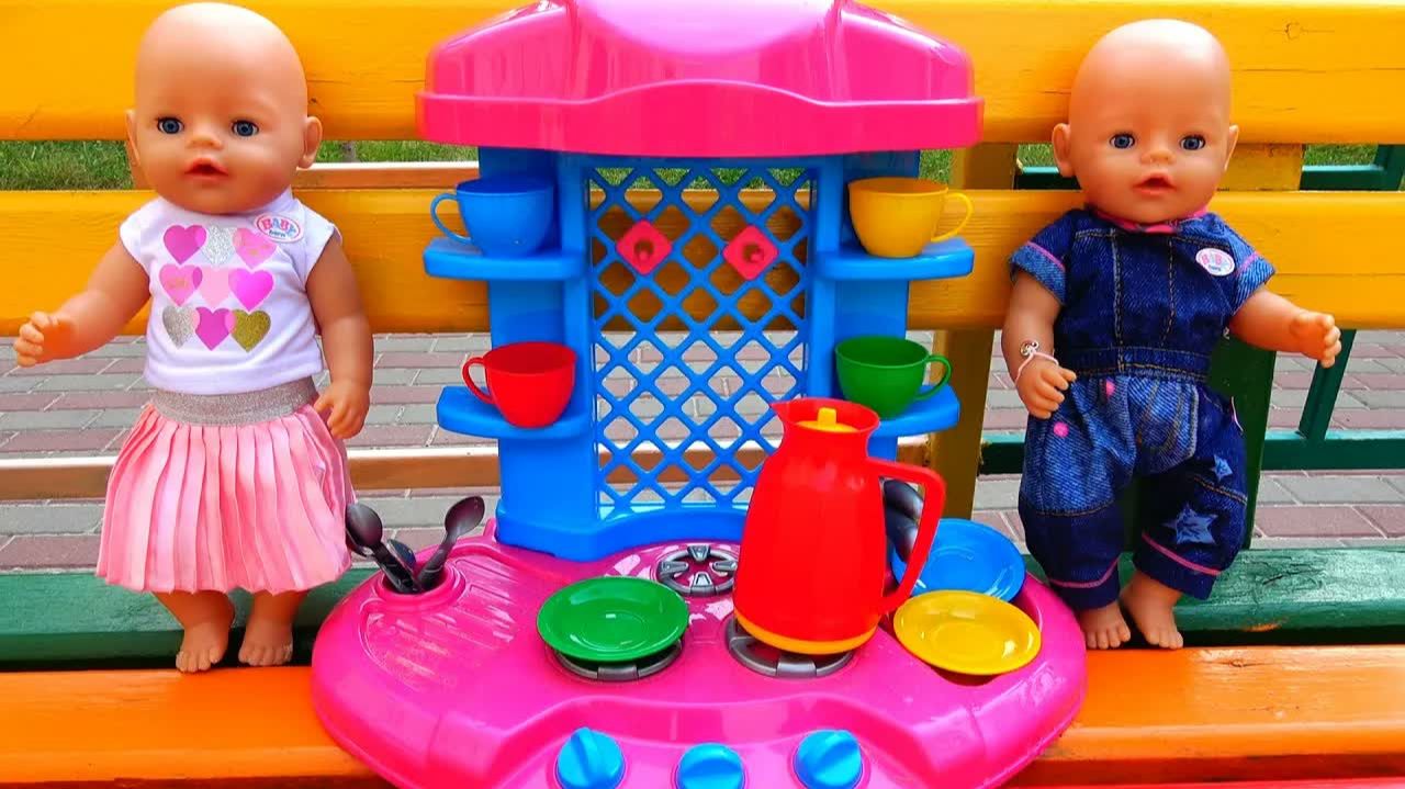 Baby dolls playing with toy kitchen