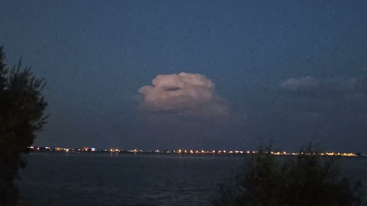 Glowing Storm Cloud Over City Lights  Светящееся штормовое облако над огнями города
