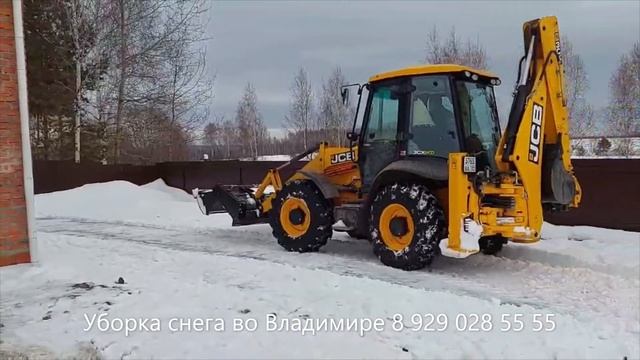 Экскаватор погрузчик трактор JCB чистит снег