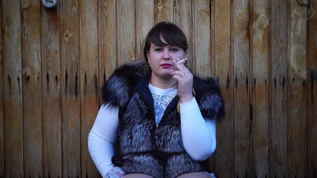Thick Woman Smokes On The Street.