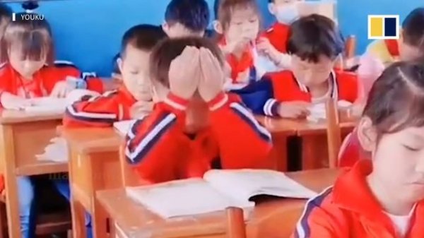 Student in China tries to ‘absorb’ knowledge from book using hands