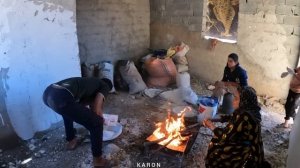 nomadic life in Iran: The mother of a nomadic family baking local bread for her children