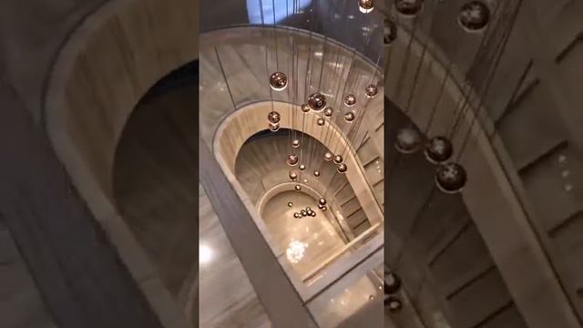 Grand Curved Staircase with Glass Railing and Marble Cladding смотреть онлайн