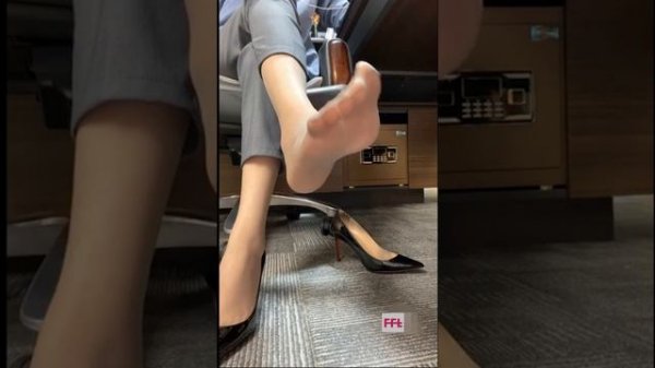an office girl shows her nylon stocking feet soles