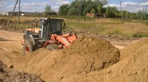 Hitachi ZW220 pushing sand