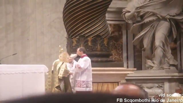 Mons. Marini tidying up Pope's hair at the end of Holy Mass