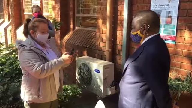 Minister Dr Blade Nzimande screened by an official from HigherHealthSA during a visit to TUT. смотреть онлайн