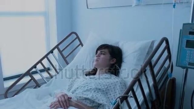 sick young woman with an iv recovering in a hospital bed next to a window slow motio смотреть онлайн