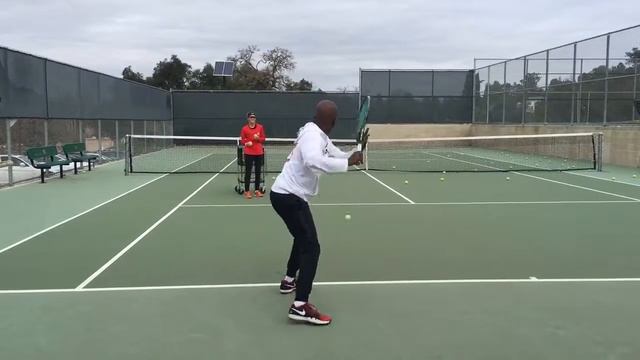 TeamG's Coach G demonstrating getting under the ball and bending it into the court. смотреть онлайн