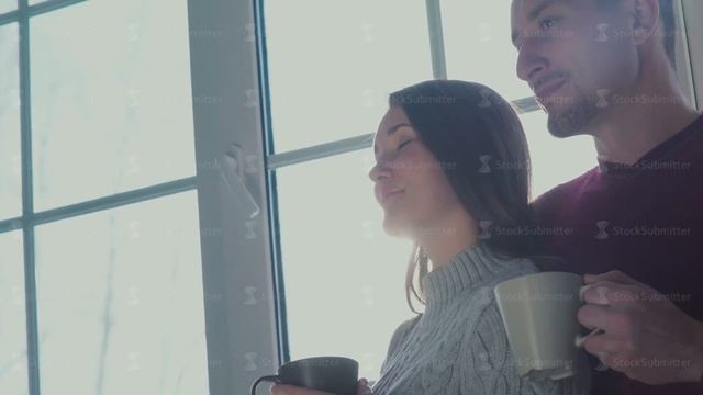 Man and woman standing at the window and enjoy the romantic atmosphere смотреть онлайн