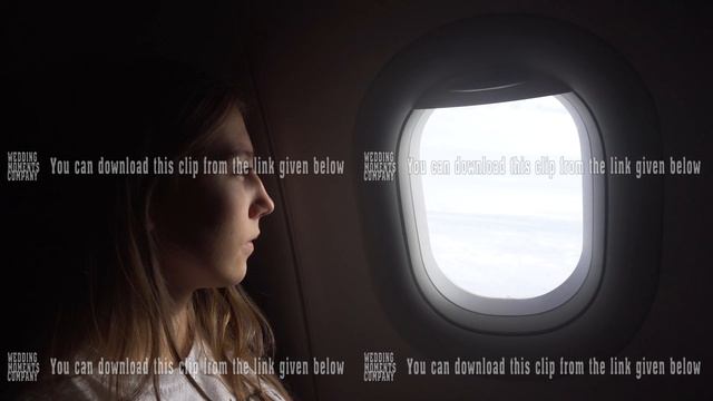 Girl sitting by aircraft window and looking outside. смотреть онлайн