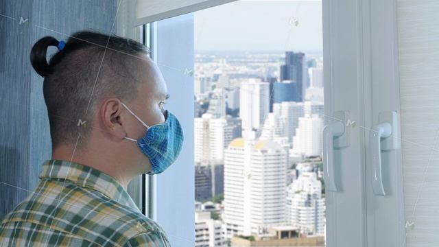 Adult sad man in face medical mask looks through window смотреть онлайн