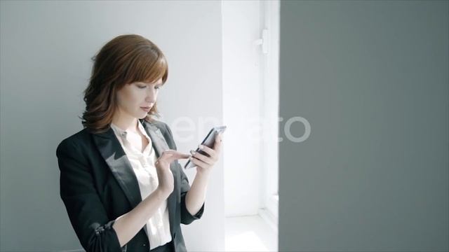 Young Businesswoman Using Smartphone Standing By Window in Office Interior | Stock Footage - смотреть онлайн