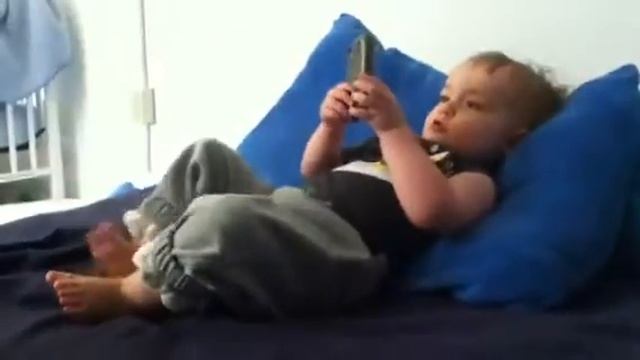 17.5 months - playing with a cell phone in bed смотреть онлайн