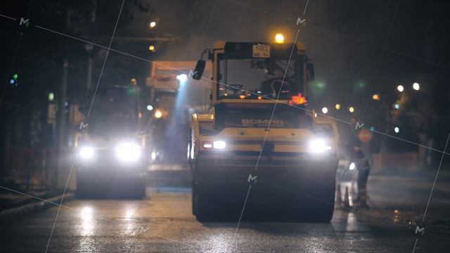Novosibirsk region, September 7, 2019. Two road rollers compact the asphalt in the city at night смотреть онлайн