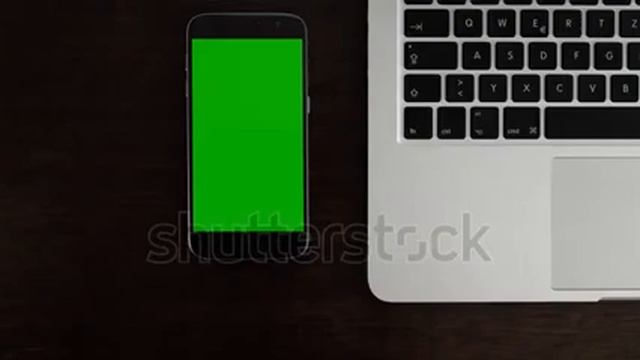TOP VIEW MOCKUP OF A SMARTPHONE WITH AN EMPTY GREEN SCREEN NEXT TO A MODERN OFFICE NOTEBOOK COMPUTE смотреть онлайн