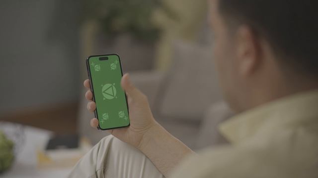Free iPhone 14 pro Green screen footage 4k _ Man touching zoom scroll iPhone on sofa in living room смотреть онлайн