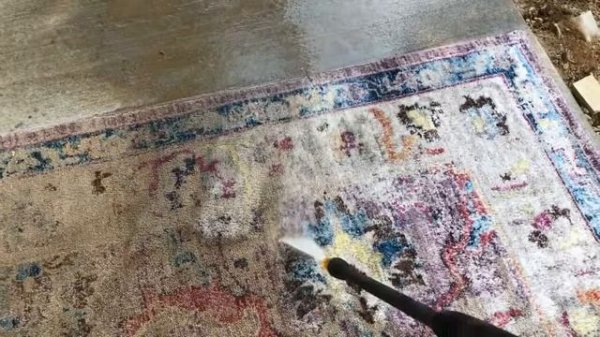 Cleaning an area rug with a power washer