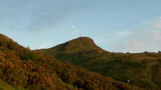 A Gibbous Moon Hangs Over The Imposing Mound Of Arthur's Seat - Edinburgh