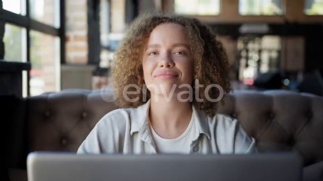 Girl Looks Out Window Smiles and Looks Into Camera While Sitting with Laptop in Cafe | Stock Foo... смотреть онлайн
