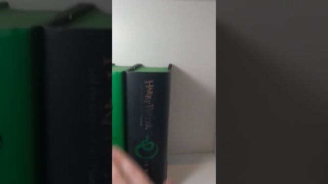 Filling a bookcase with Harry Potter books | Slytherin hardback books and hardback Deathly Hallows смотреть онлайн