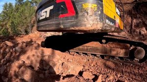 Бульдозер Caterpillar D7G и экскаватор убирают большой камень