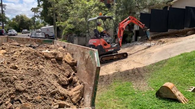 Mini Excavator hydraulic hammer breaking up concrete