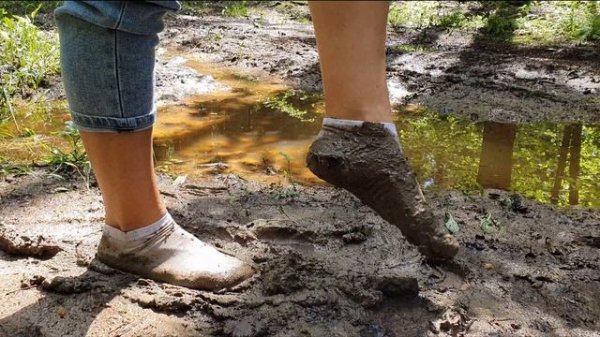 Muddy white socks, white socks in mud, dirty white socks, socks in muddy puddles walks (scene 495)