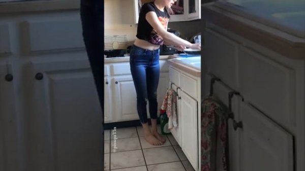 Girl pees in pants while doing dishes