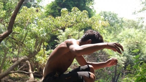 Survival in the rainforest - cooking red fish on a rock