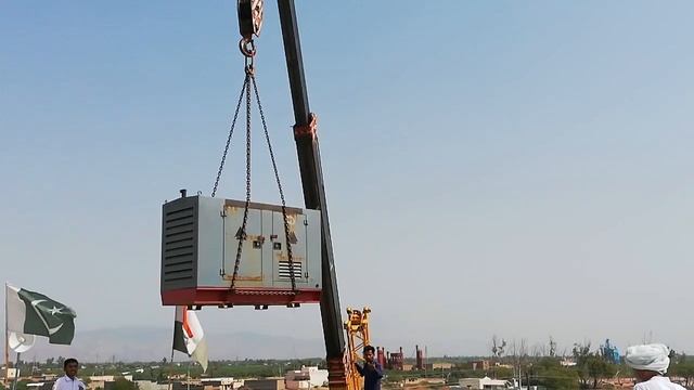 The heavy generator is being lifted by the mobile crane. смотреть онлайн