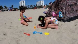 Kids are playing on the beach with sand and having fun