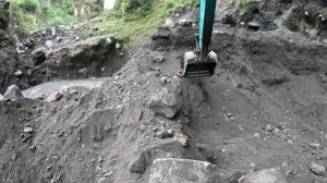 Строительство, экскаватор копает чёрный песок