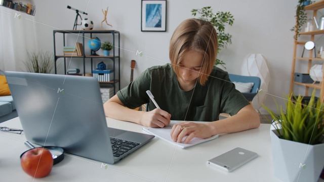 Smart teenager typing with laptop then writing information in notebook learning at home смотреть онлайн