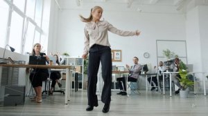 Happy business lady dancing in office celebrating success while staff clapping hands sitting at