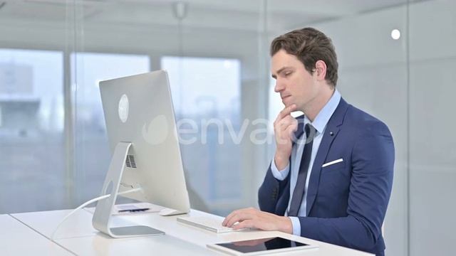 Young Businessman Thinking and Working on Desk Top in Office | Stock Footage - Envato elements смотреть онлайн