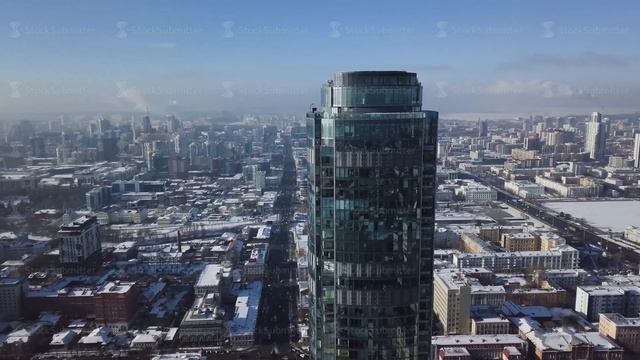 Top view of the amazing glass tower or the business center in the background of a winter city смотреть онлайн