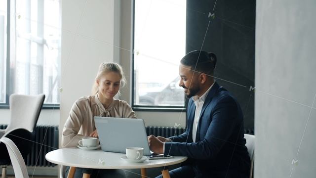 Cheerful business partners man and woman talking and using laptop in modern cafe смотреть онлайн