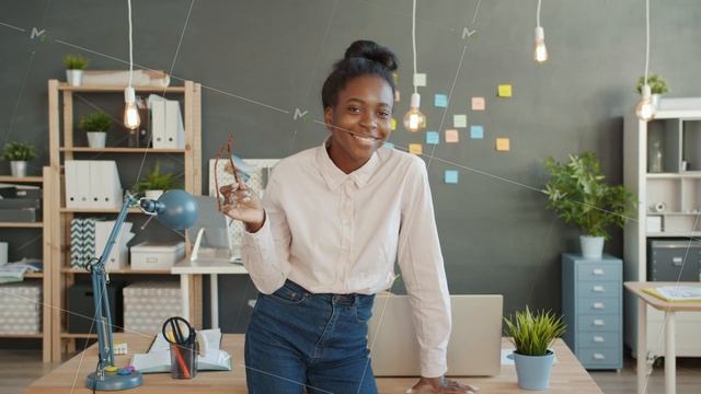 Portrait of joyful business lady smiling holding glasses in modern creative office смотреть онлайн
