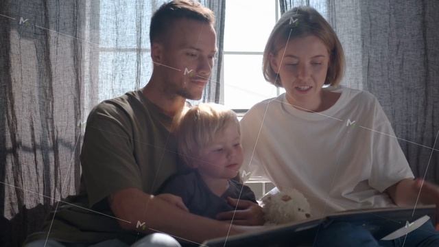 A Family With A Small Child Reading A Book