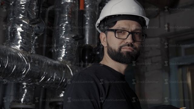 Man In Helmet, Glasses, Black T-shirt Looks Into The Camera Smiling