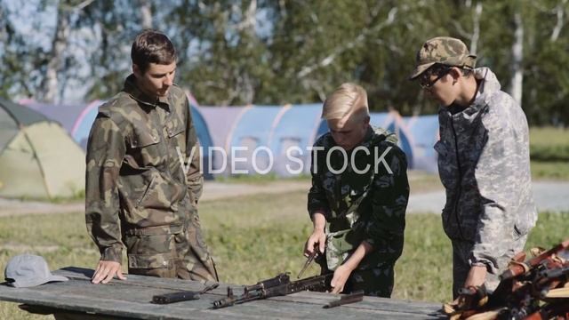 Russia, Novosibirsk, 2018. Three cadets recruit study AK-47 Kalashnikov assault rifle смотреть онлайн